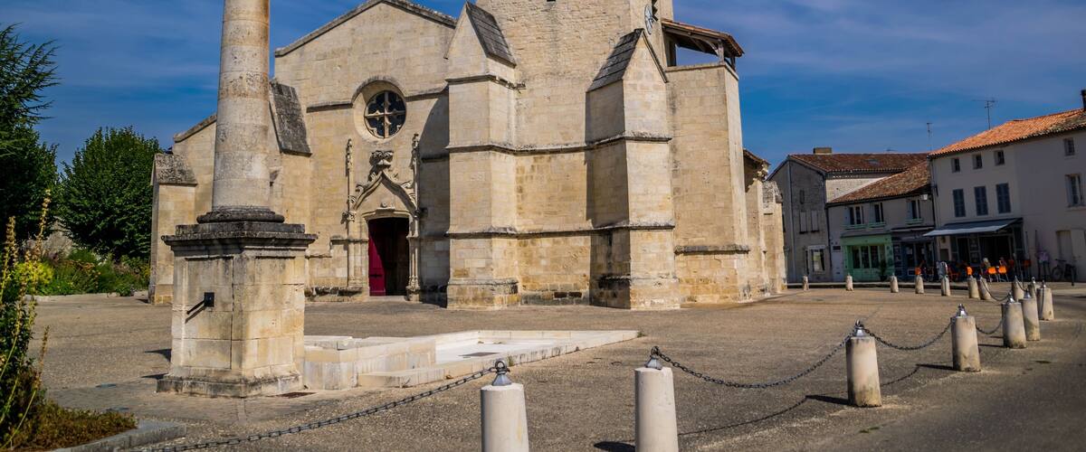 A historic church with a bell tower and a large arched doorway.