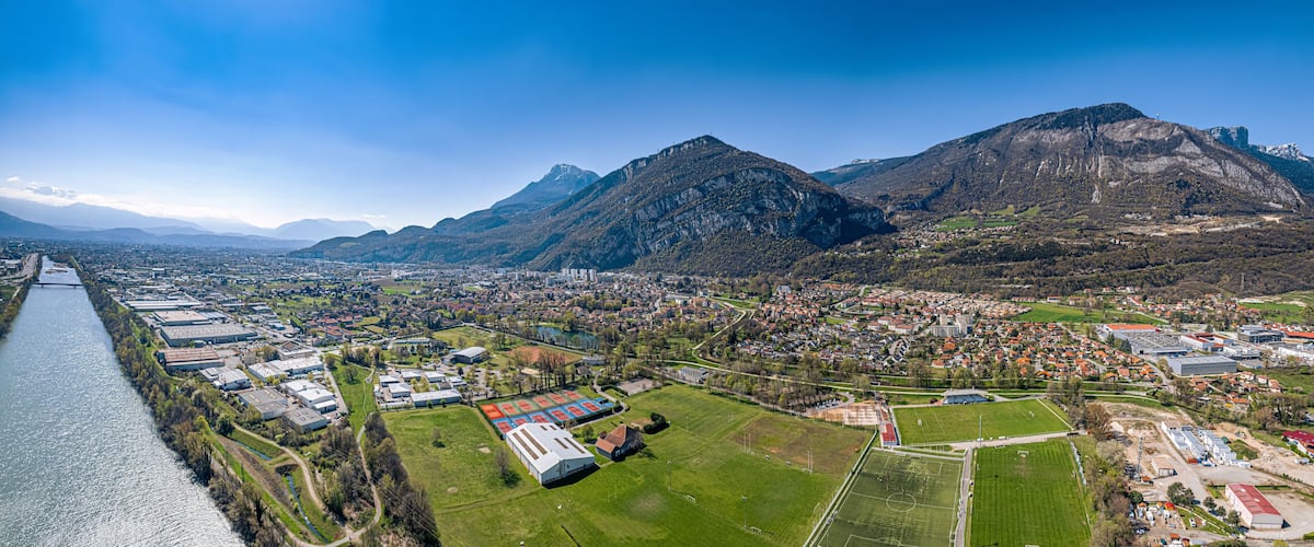 A river, industrial buildings, residential areas, and mountains.