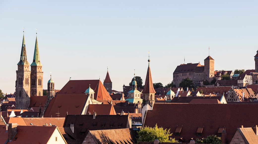 A historic town with prominent church spires, a castle, and a mix of traditional and modern architecture.