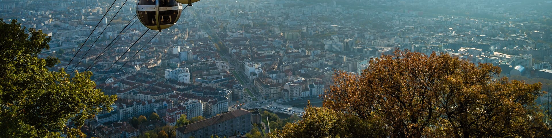 A cable car system with gondolas over a cityscape.