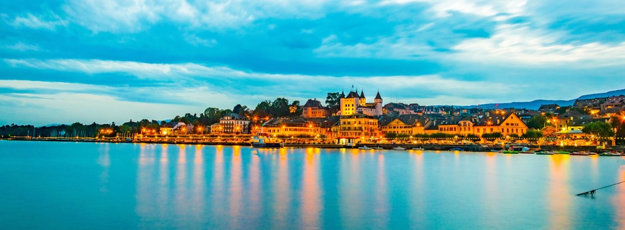 Sunset view of a white Palace in Nyon overlooking the Geneva lake in Switzerland