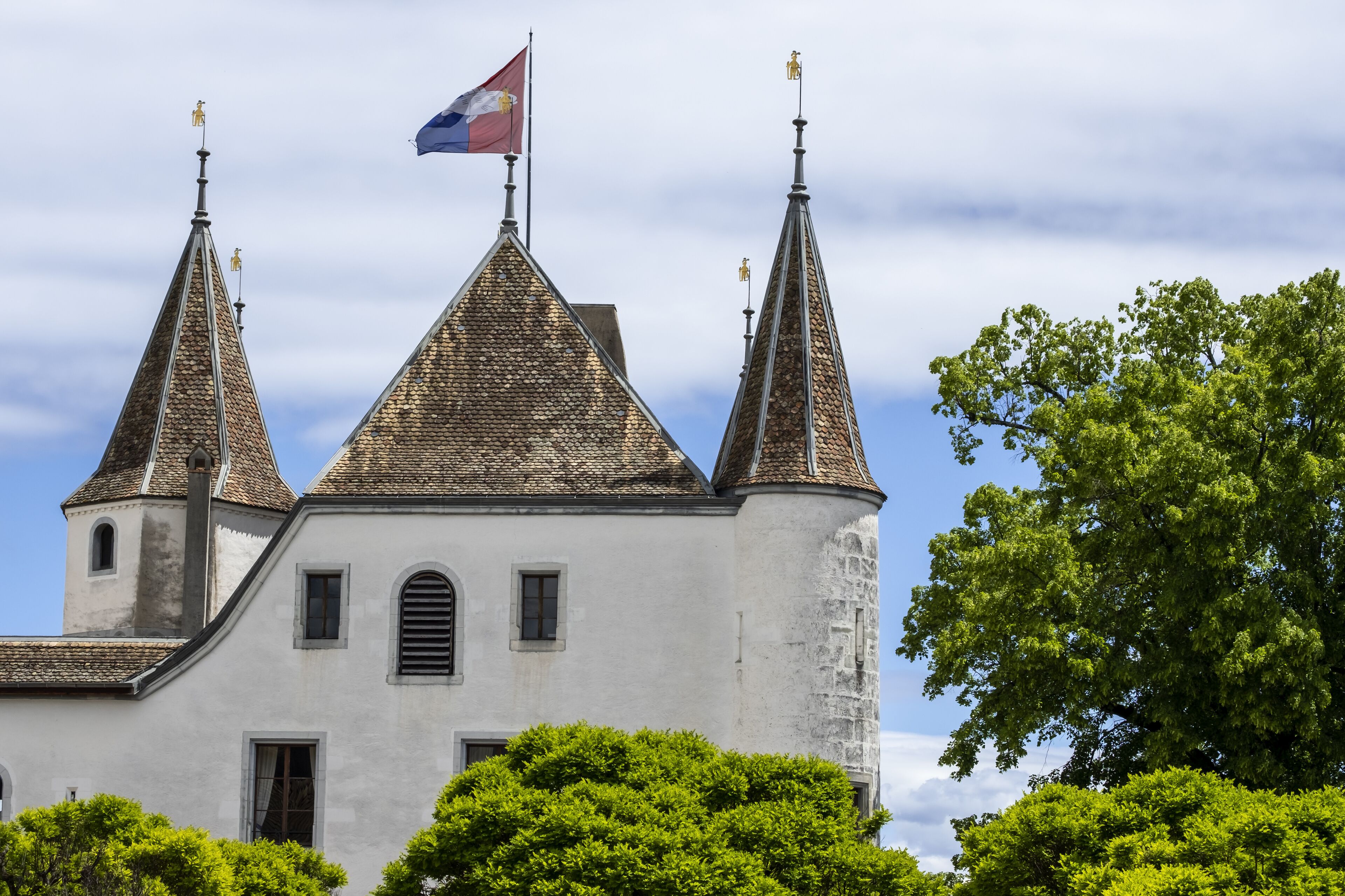 turret of castle of Nyon and flag of canton of Vaud in Switzerland