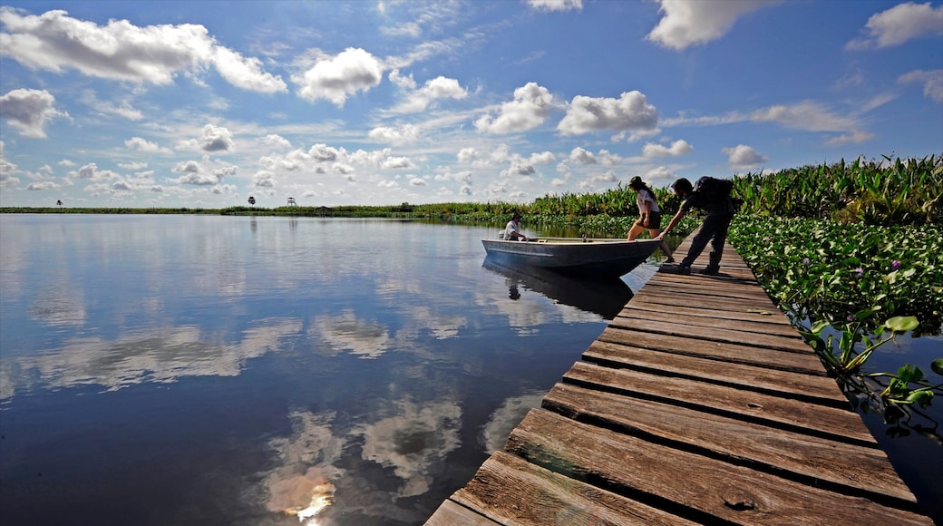 Formosa featuring boating and a river or creek as well as a small group of people