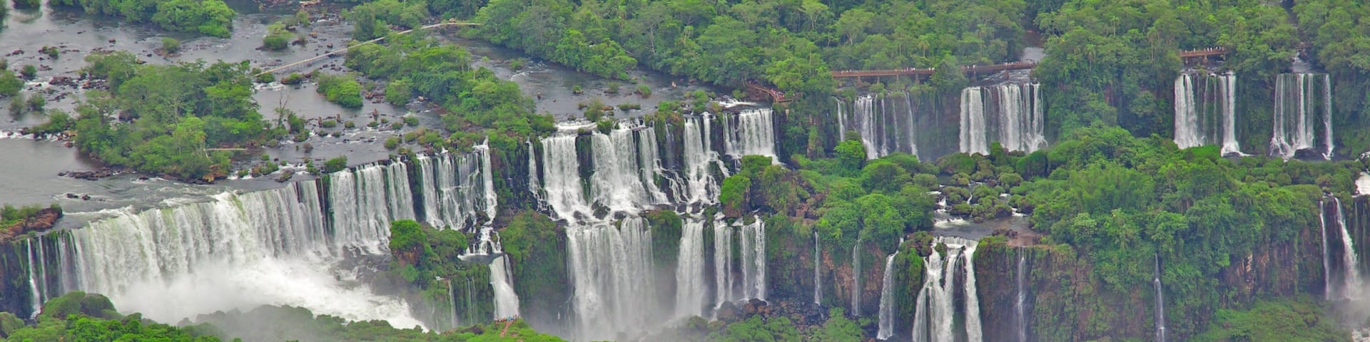 A series of waterfalls surrounded by dense green forest.