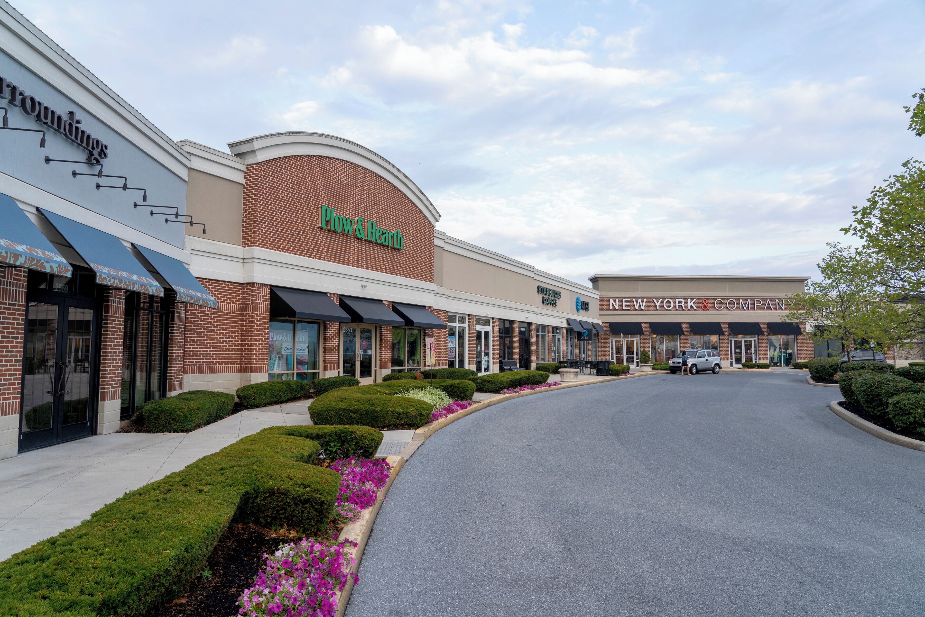 A shopping center with a 'Plow & Hearth' store and a 'New York & Company' store.