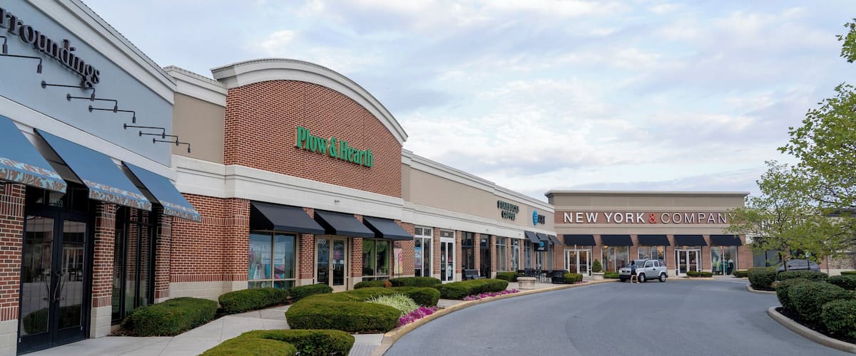 A shopping center with a 'Plow & Hearth' store and a 'New York & Company' store.