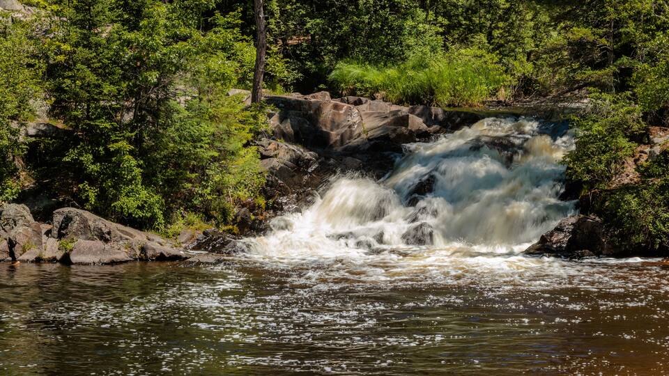 Twelve Foot Falls on the Pike River within Twelve Foot Falls County Park near Dunbar, Wisconsin flowing fast in early June