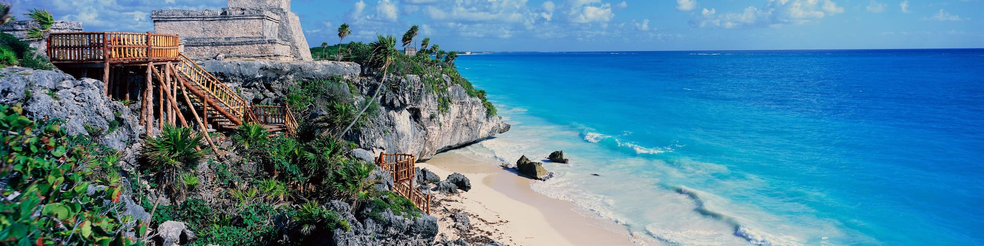 A Panoramic of Mayan ruins of Ruinas de Tulum (Tulum Ruins) and El Castillo at sunset, with beach and Caribbean Sea, in Quintana Roo, Yucatan Peninsula, Mexico