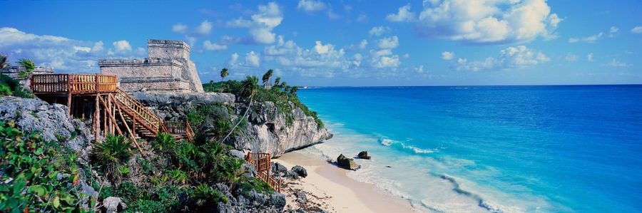 A Panoramic of Mayan ruins of Ruinas de Tulum (Tulum Ruins) and El Castillo at sunset, with beach and Caribbean Sea, in Quintana Roo, Yucatan Peninsula, Mexico