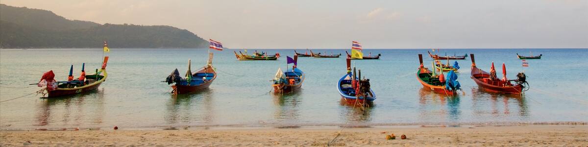 Kata Beach which includes a bay or harbor, a sandy beach and boating