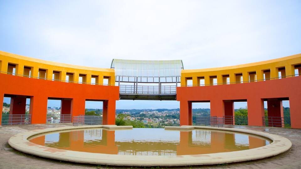 A modern building with orange walls and a central glass structure.