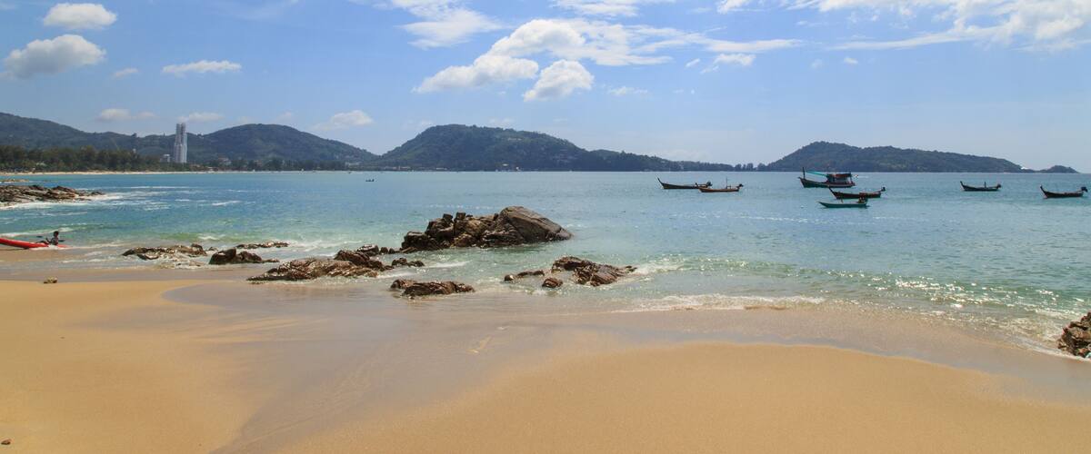 The beach and blue sky /Fishing boat on the sea in phuket Thailand/Beautiful beach under sunshine in Andaman sea/At kalim beach nearly Patong beach Phuket Thailand/