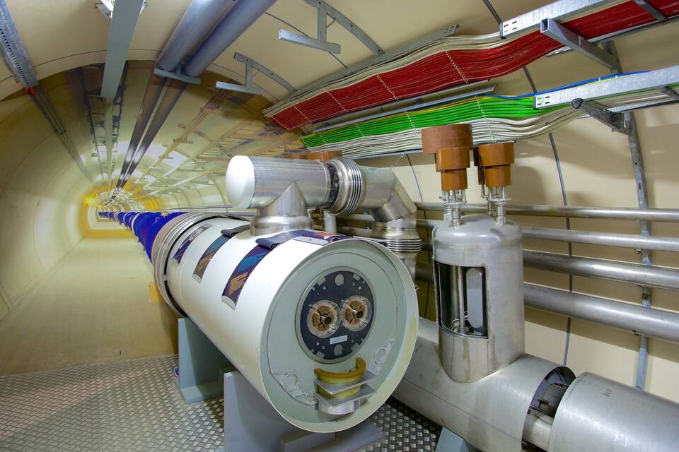 A large industrial machine with a cylindrical component and multiple pipes.