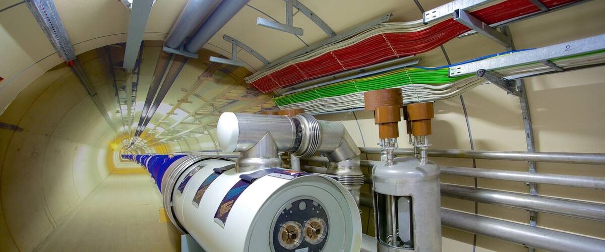 A large industrial machine with a cylindrical component and multiple pipes.