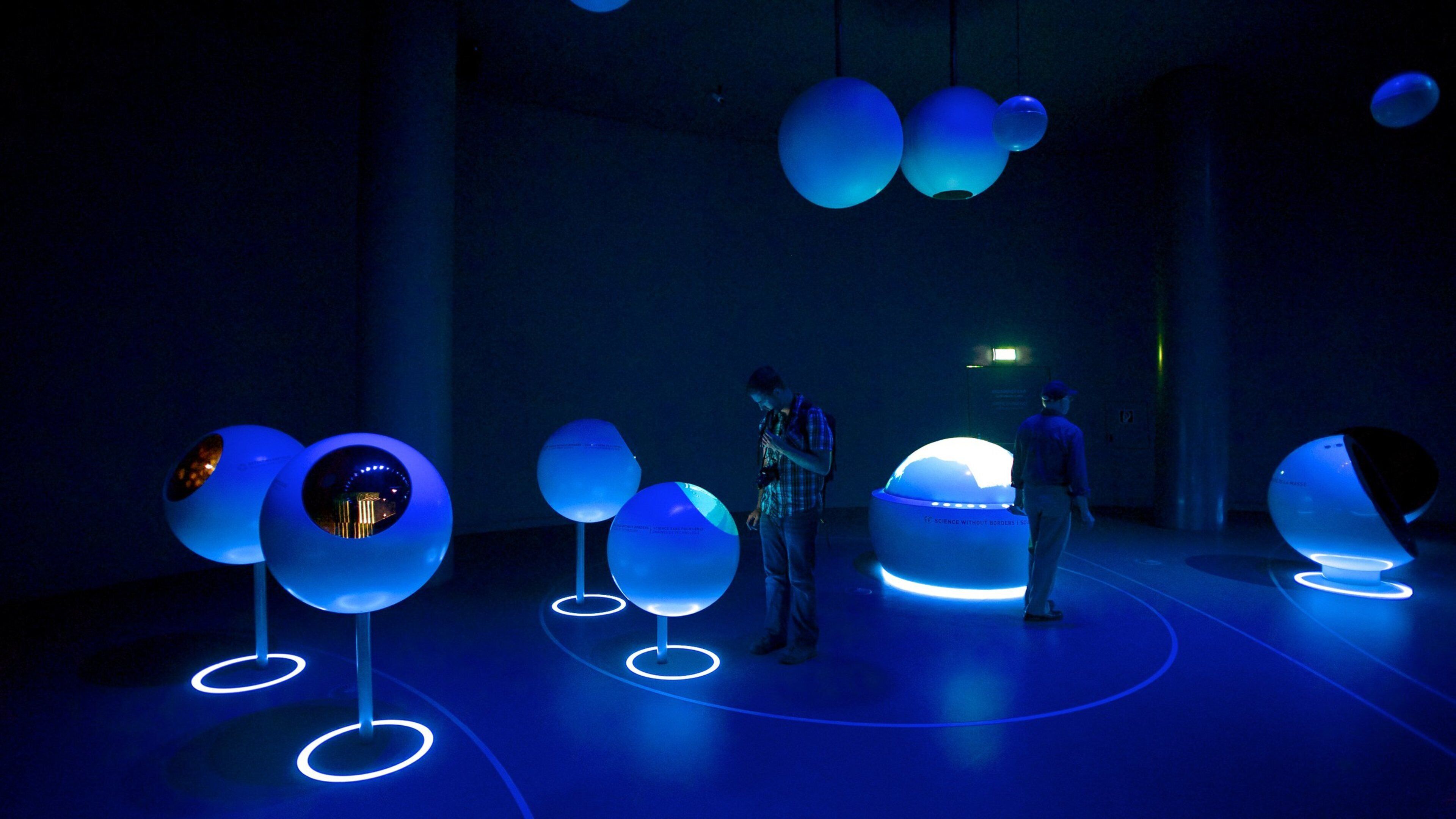 CERN which includes modern architecture and interior views as well as a small group of people