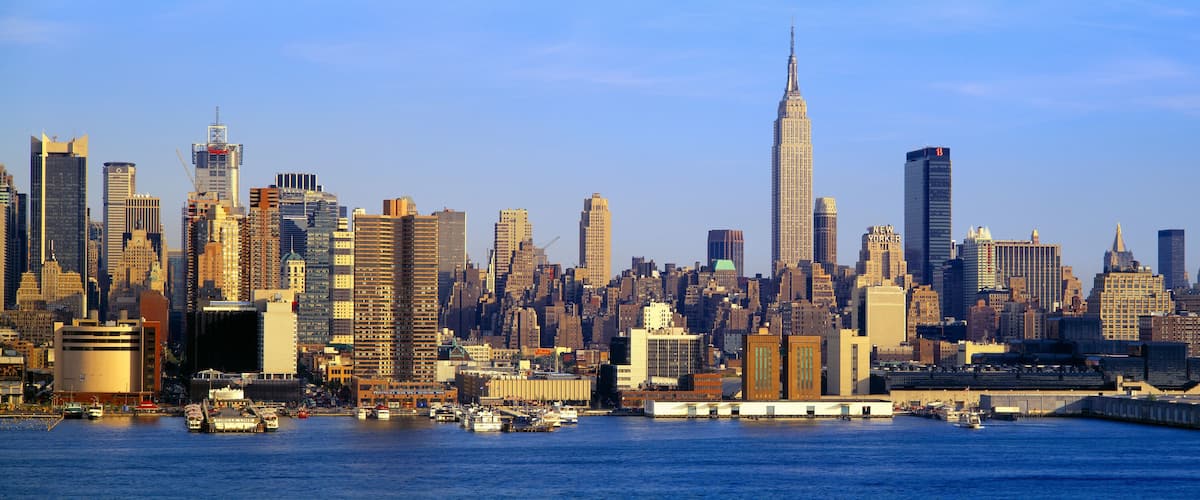 A city skyline with the Empire State Building and numerous other high-rise buildings.