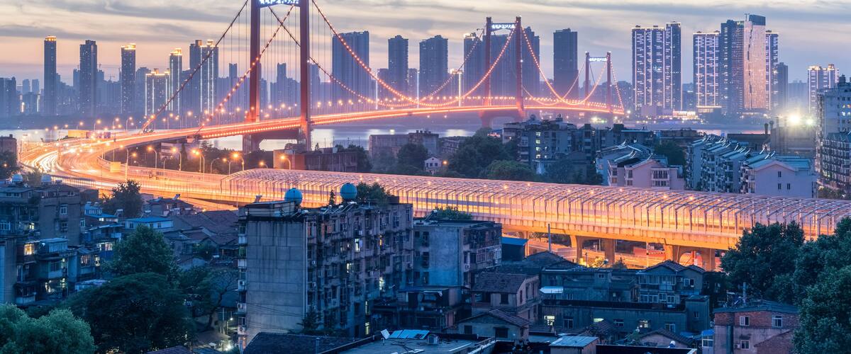 A cityscape with a prominent bridge and high-rise buildings.