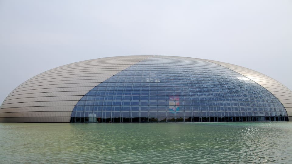 Tiananmen Square which includes modern architecture, a lake or waterhole and theatre scenes