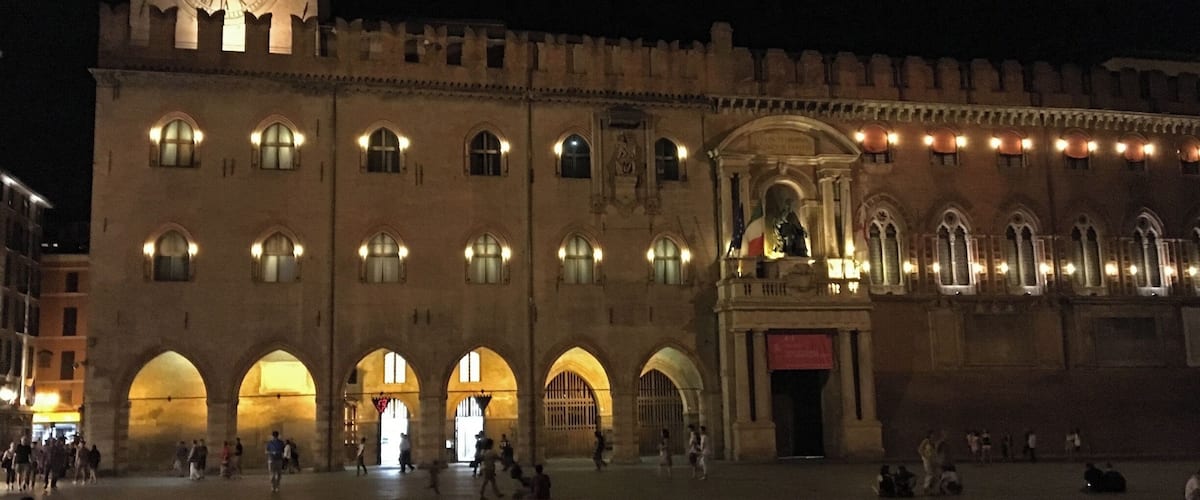 Palazzio d'Accursio on The Piazza Maggiore, Bologna at night.  The palace was once the administrative centre of Bologna. Located on the Piazza Maggiore, it was the city's Town Hall until 2008. The palace is now home to the Civic Art Collection, with paintings from the Middle Ages to the 19th century, and the town libraries.