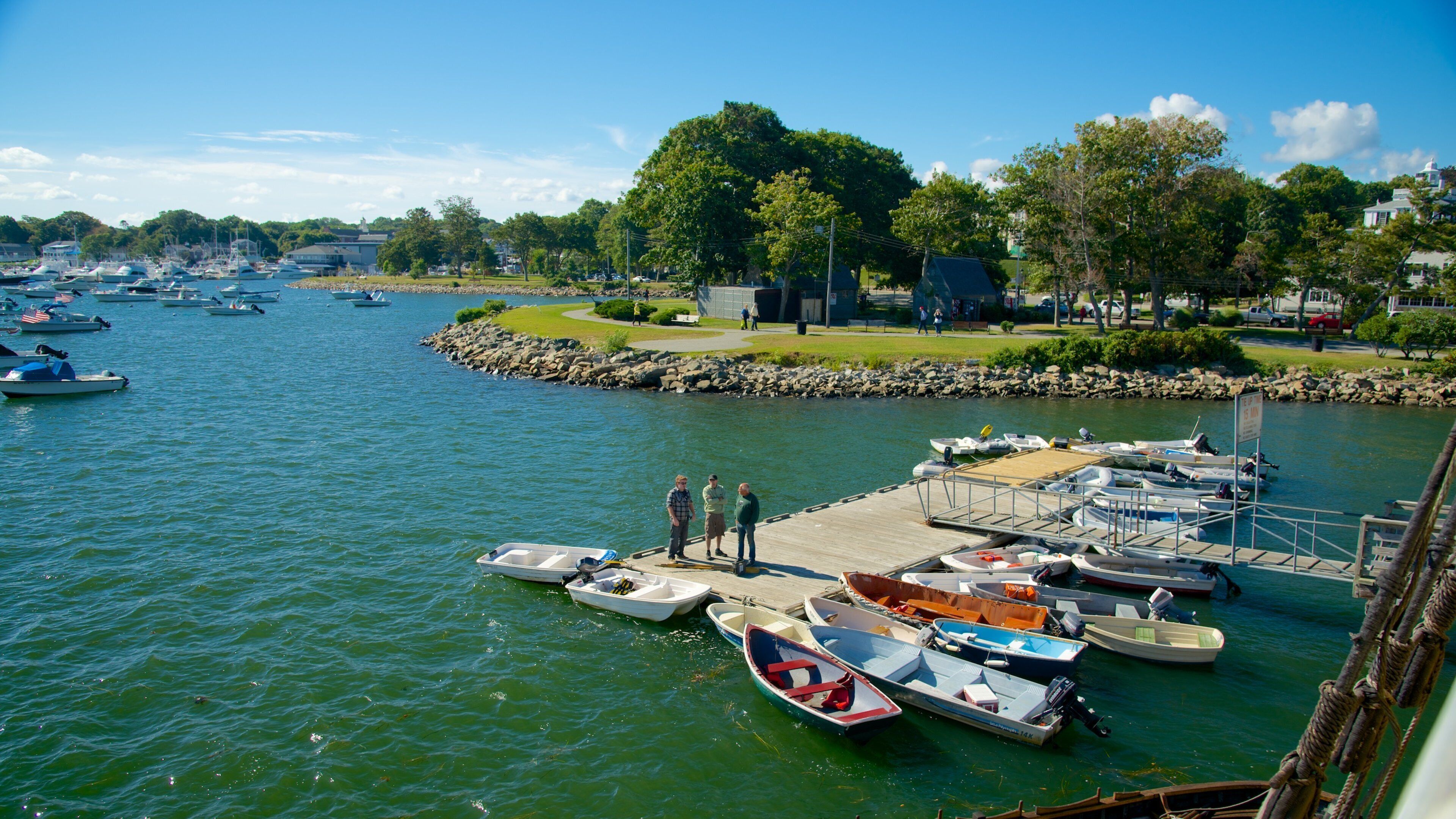 Plymouth Harbor featuring a bay or harbor as well as a small group of people