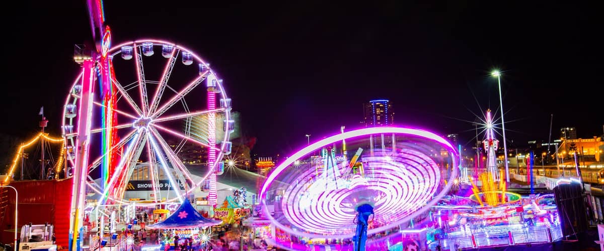 RNA Showgrounds featuring rides and night scenes