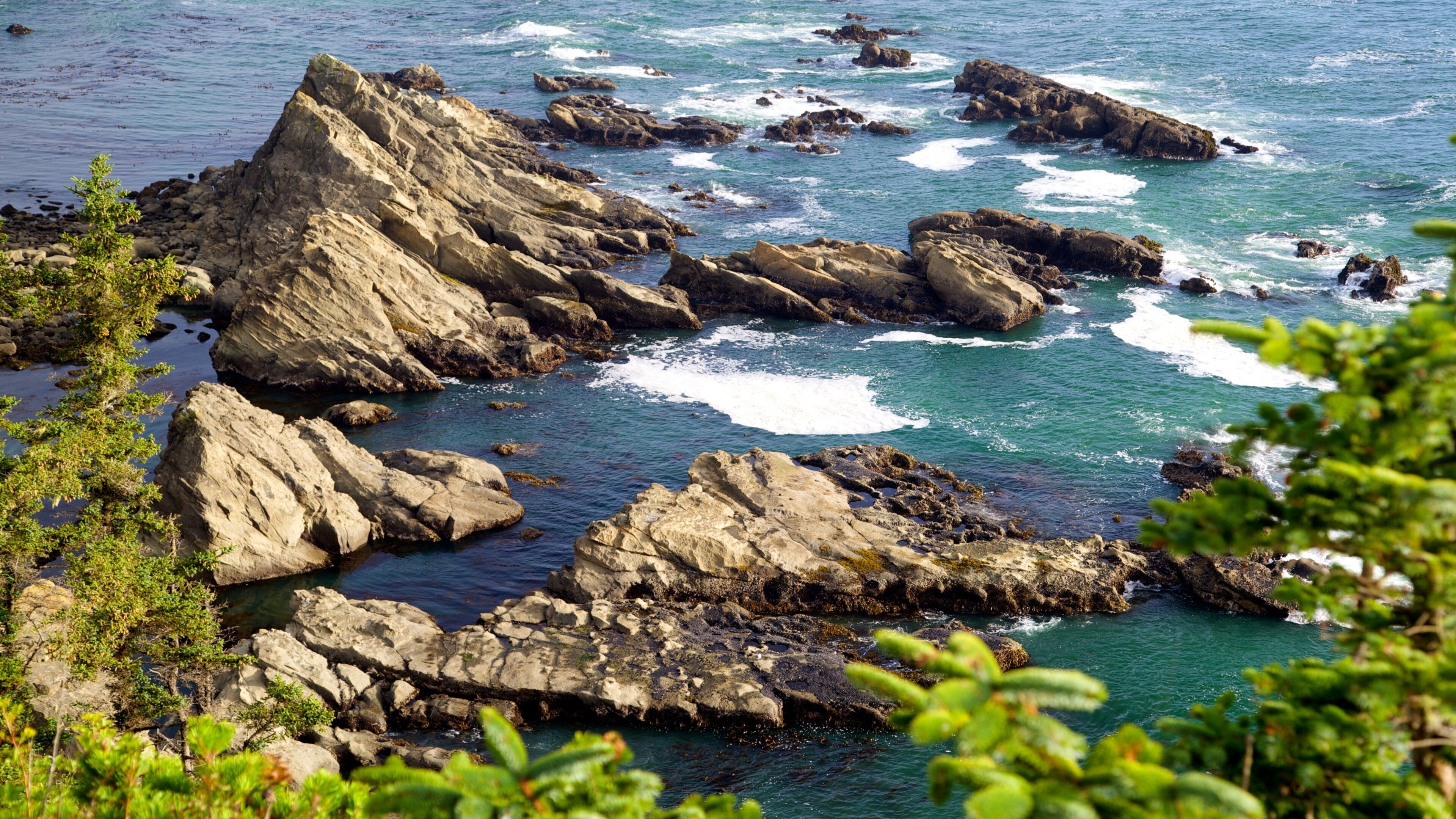 A rocky coastline with waves crashing against the rocks.