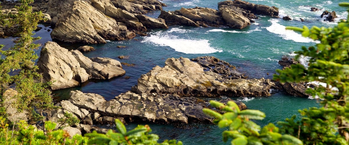 A rocky coastline with waves crashing against the rocks.