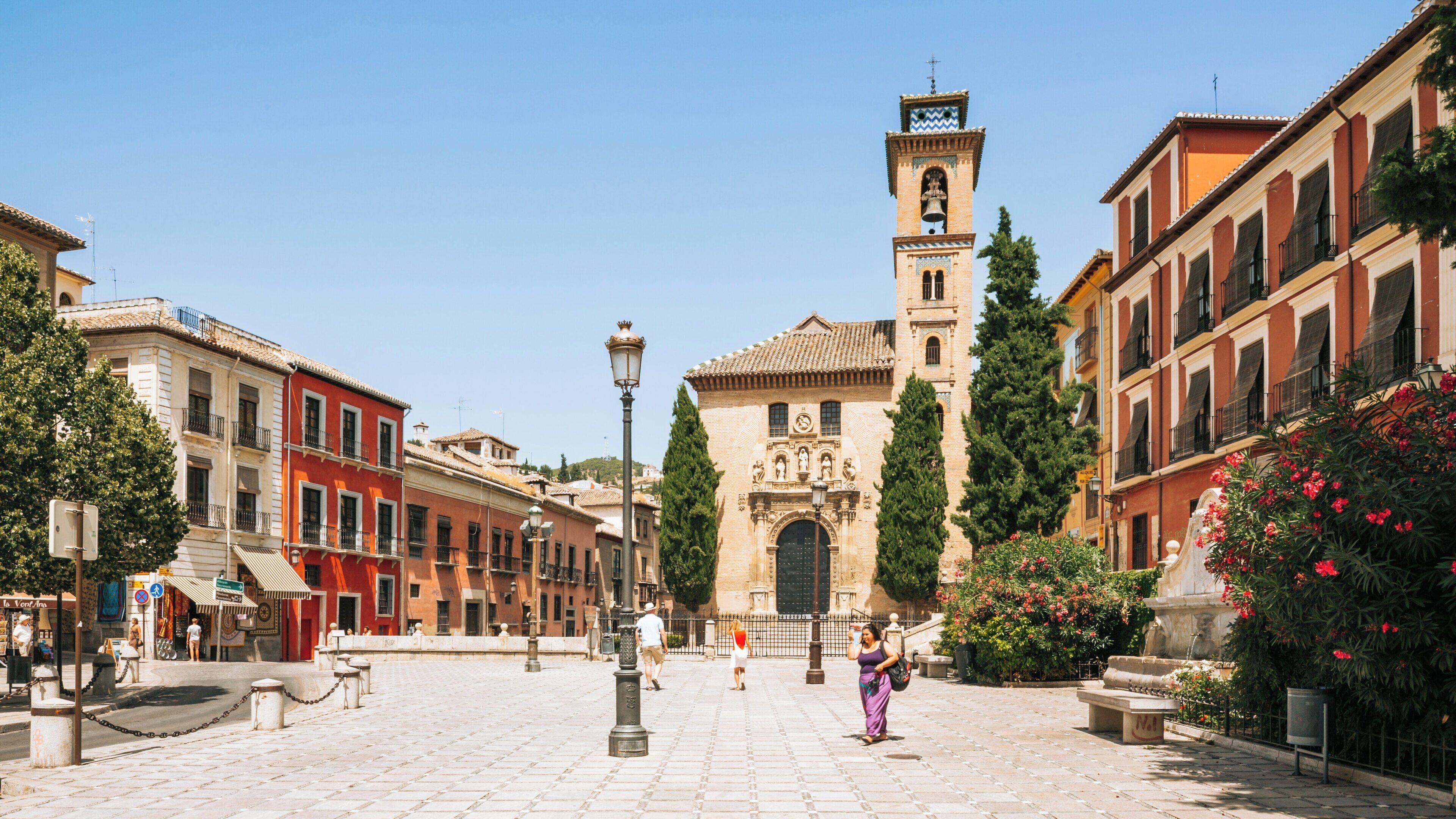 Vibrant atmosphere and historic architecture of Plaza Nueva in Albaicin, Granada during a sunny day