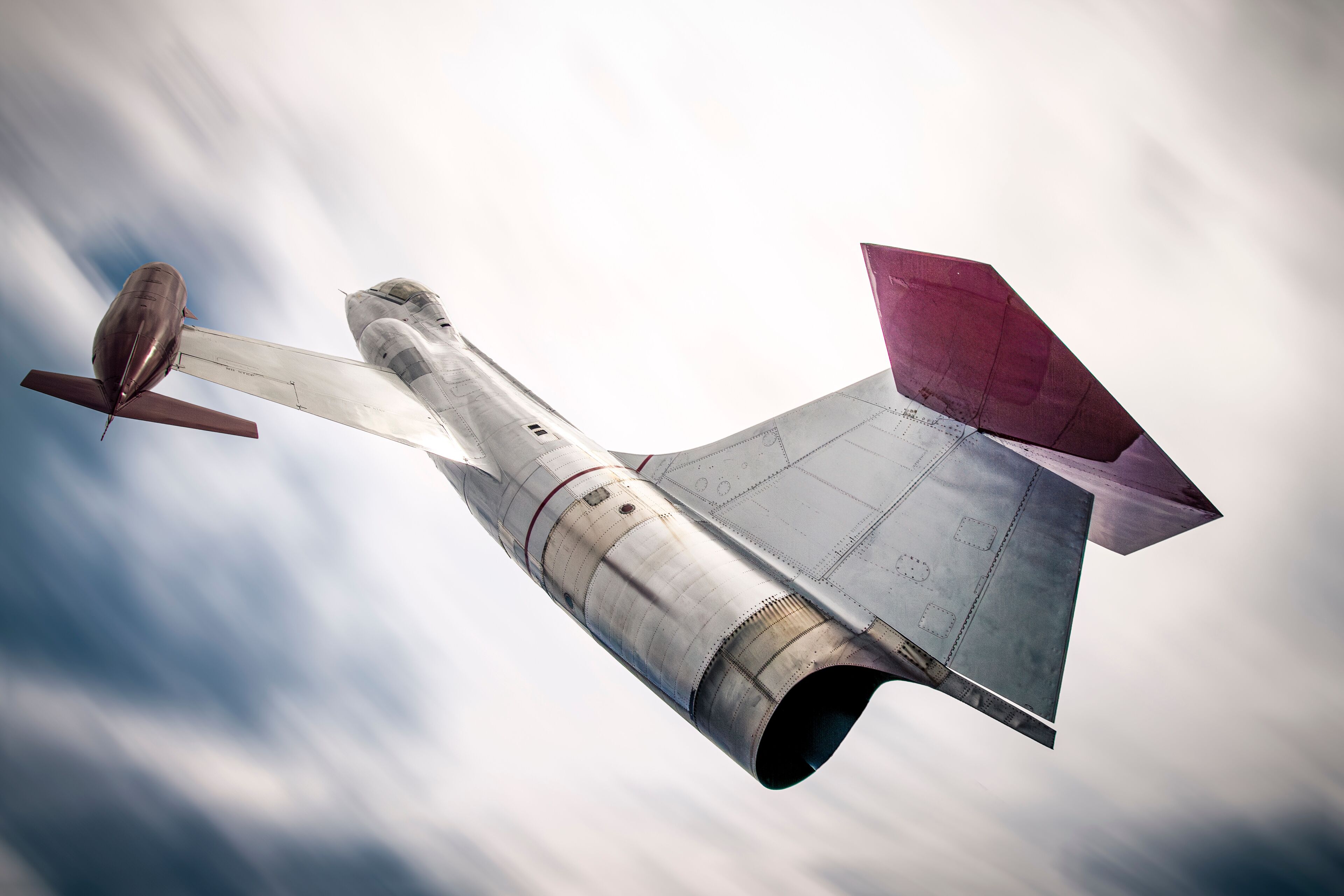 Backside of a CF-104 Starfighter jet against a blurry sky.
