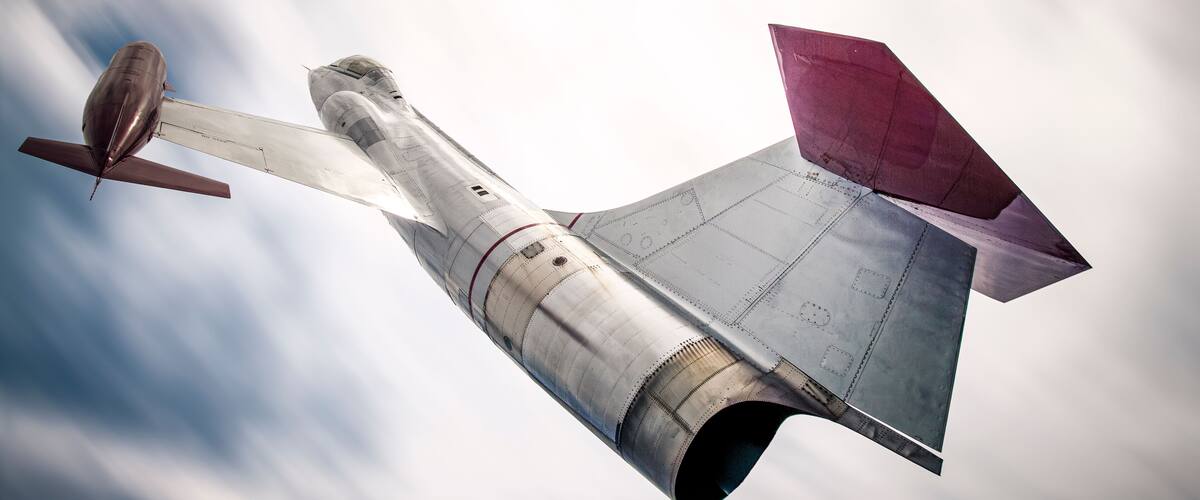 Backside of a CF-104 Starfighter jet against a blurry sky.