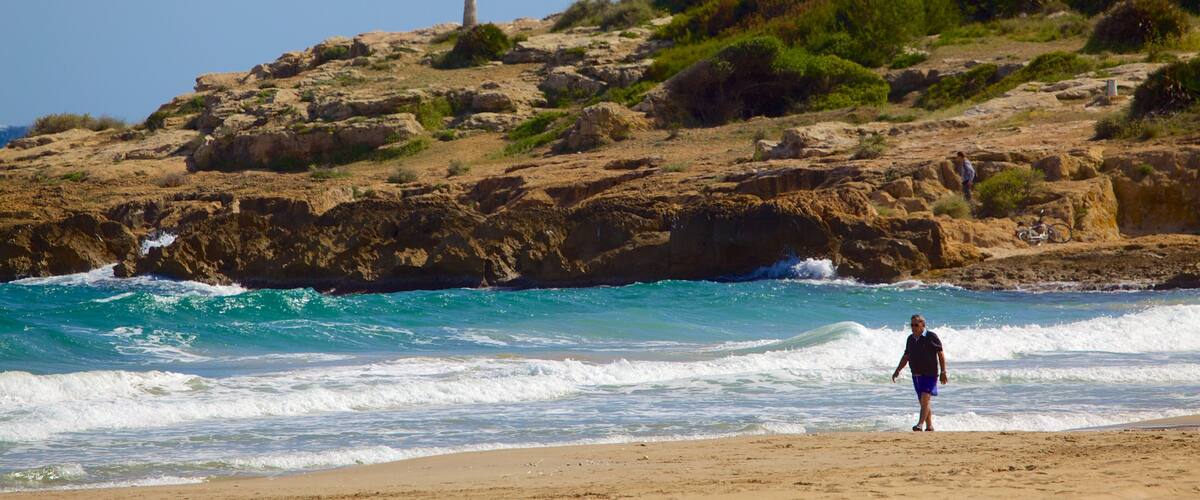 L\'Arrabassada Beach which includes a sandy beach, general coastal views and rugged coastline