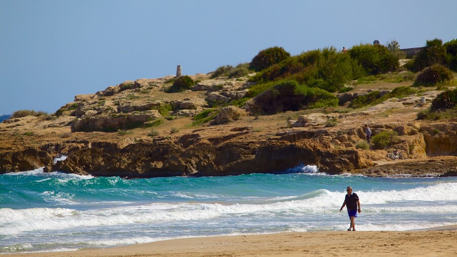 L\'Arrabassada Beach which includes a sandy beach, general coastal views and rugged coastline