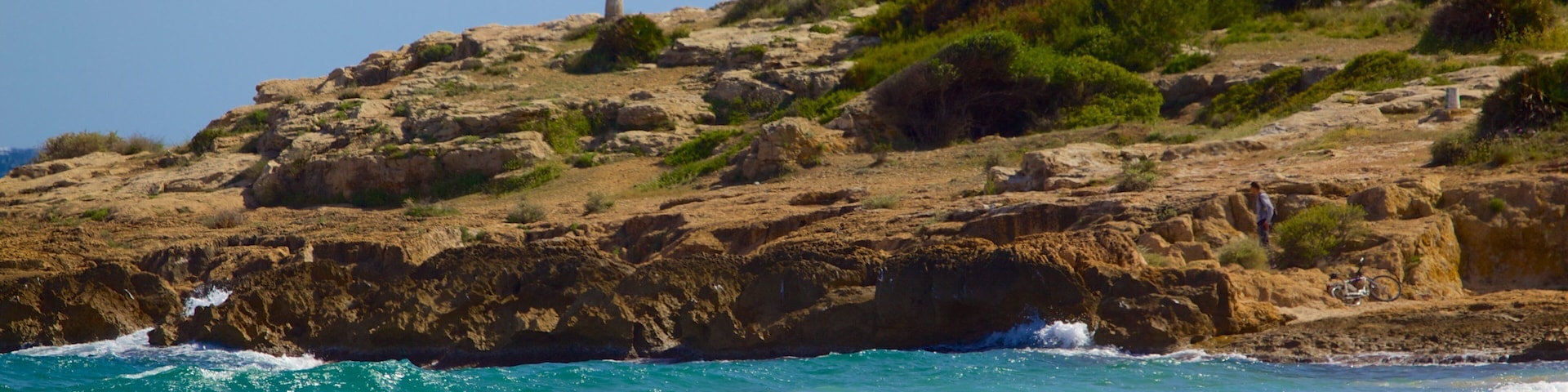 L\'Arrabassada Beach which includes a sandy beach, general coastal views and rugged coastline