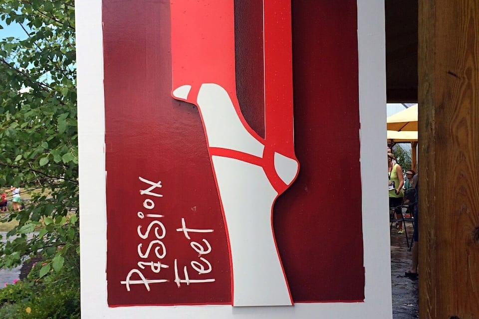 A sign for Vineyard & Wine Barn with a red and white design.
