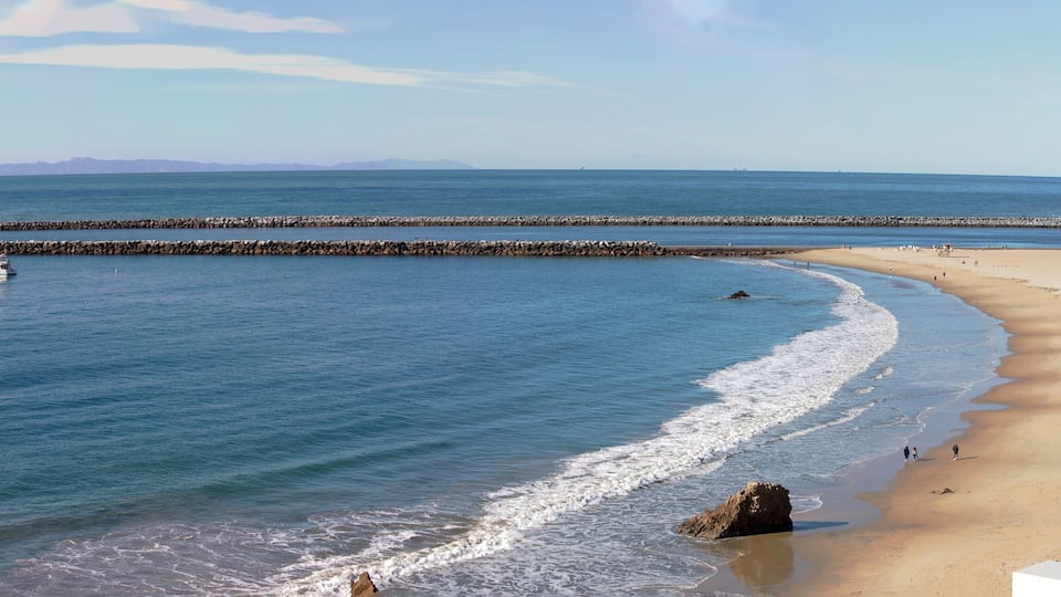 Panorama of Southern California coastline. View of the marina coastal access to the harbor from a rocky cliff. Corona Del Mar, Newport Beach, California