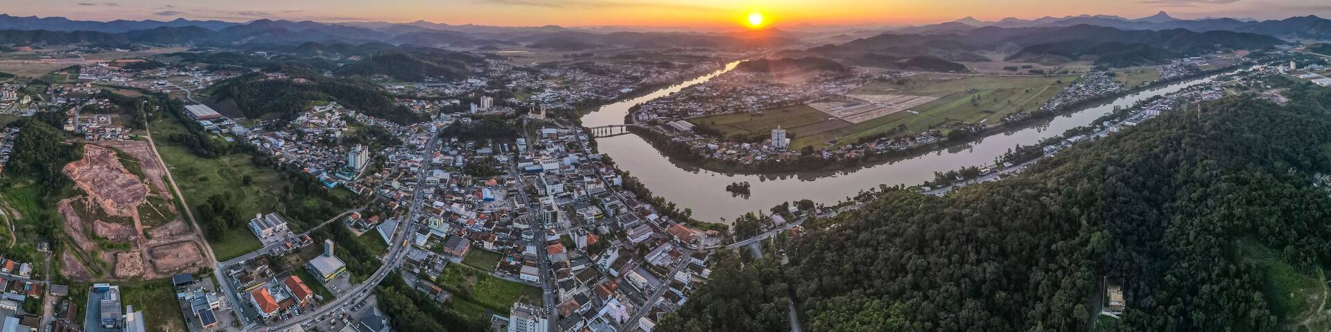 A river winding through a town surrounded by mountains.