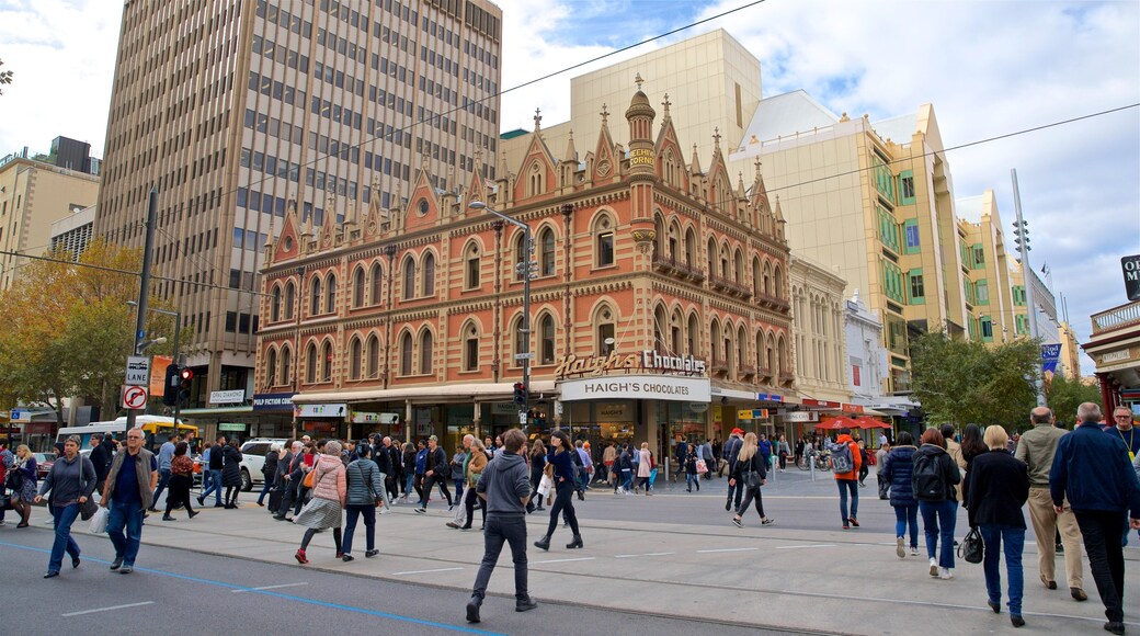 Beehive Corner Building featuring a city and street scenes as well as a large group of people