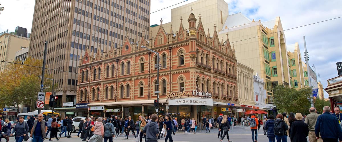 Beehive Corner Building featuring a city and street scenes as well as a large group of people