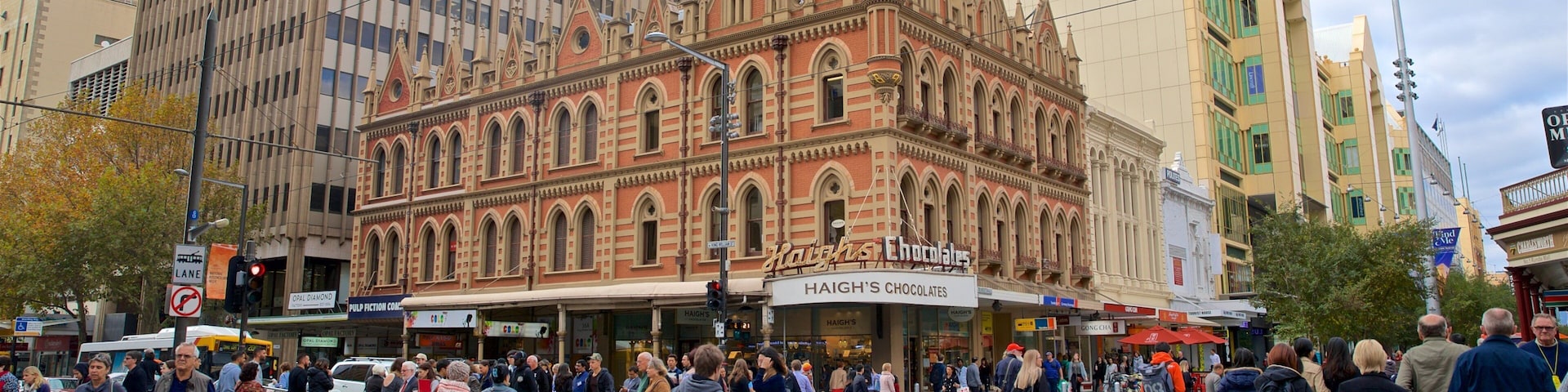 Beehive Corner Building featuring a city and street scenes as well as a large group of people