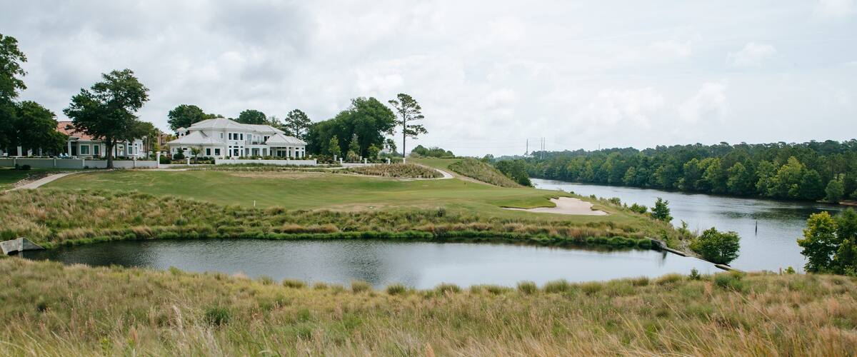 Grand Dunes Golf Course featuring a house and a river or creek