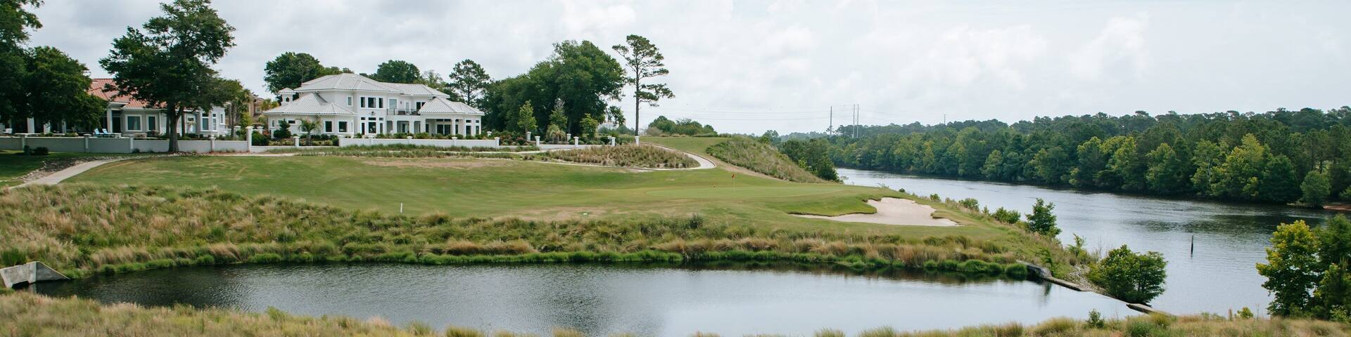 Grand Dunes Golf Course featuring a house and a river or creek