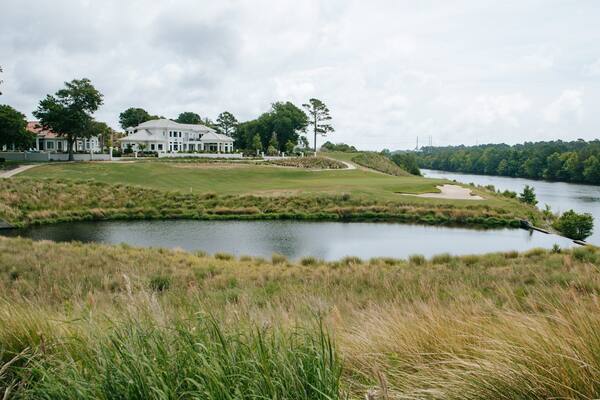 Grand Dunes Golf Course featuring a house and a river or creek