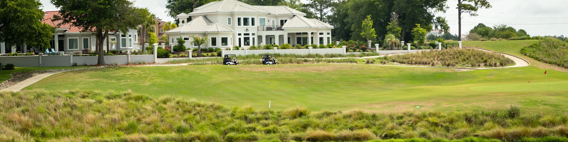 Grand Dunes Golf Course featuring a pond and golf