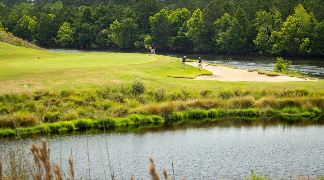 Grand Dunes Golf Course which includes golf and a pond as well as a small group of people