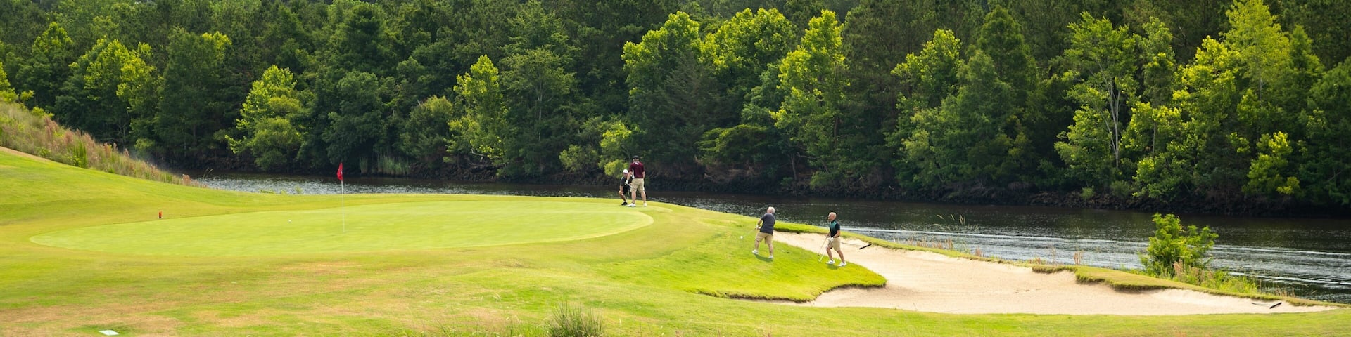 Grand Dunes Golf Course which includes golf and a pond as well as a small group of people