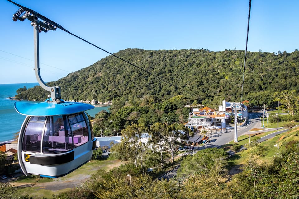 A cable car system, a coastal area, and a mountainous landscape.