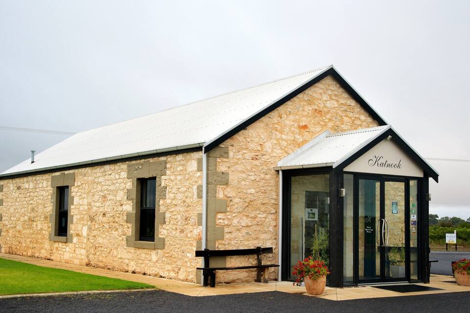 A stone building with a sloped roof and a sign reading "Katnook."