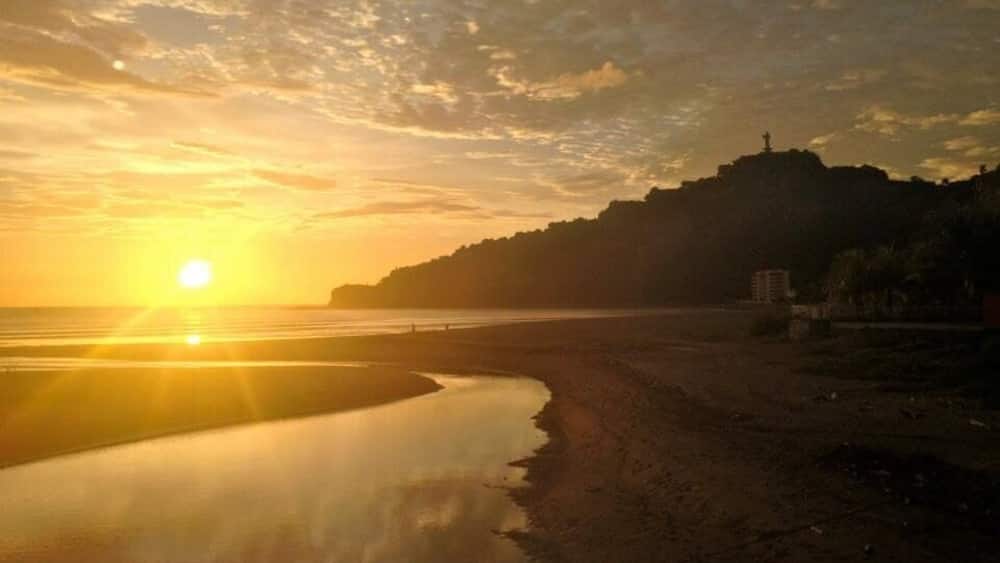 Caption---- sunset over Christ of The Mercy statue in San Juan del sur, Nicaragua