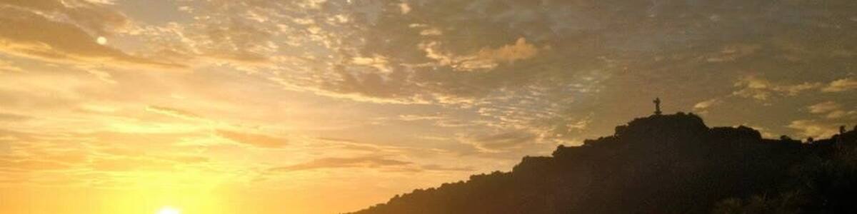 Caption---- sunset over Christ of The Mercy statue in San Juan del sur, Nicaragua