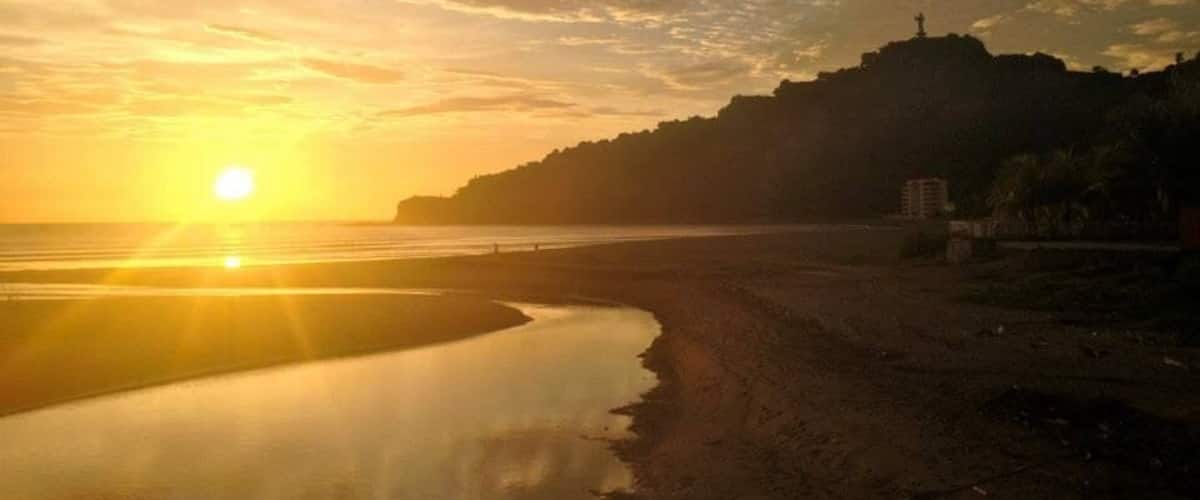 Caption---- sunset over Christ of The Mercy statue in San Juan del sur, Nicaragua